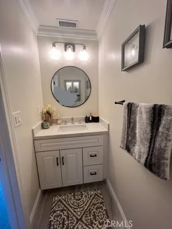 a bathroom with a sink mirror and vanity