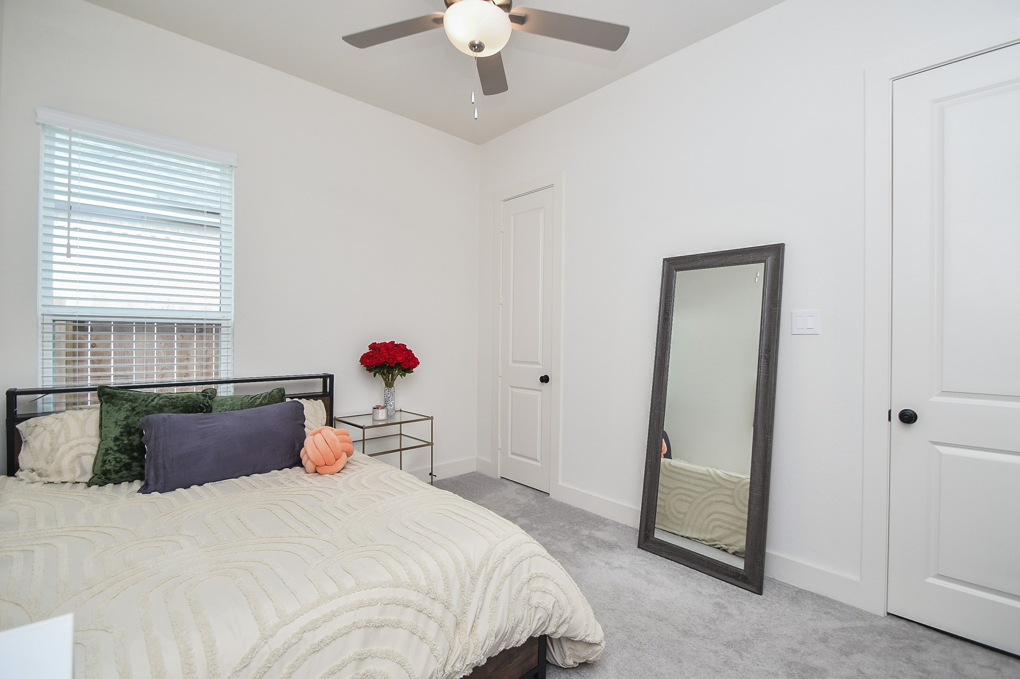 31915 Sky Rdg Lane Fulshear, TX 77441 - Photo 34 of 38 This inviting bedroom features soft neutral tones, cozy carpeting, and abundant natural light, creating a tranquil retreat perfect for relaxation.