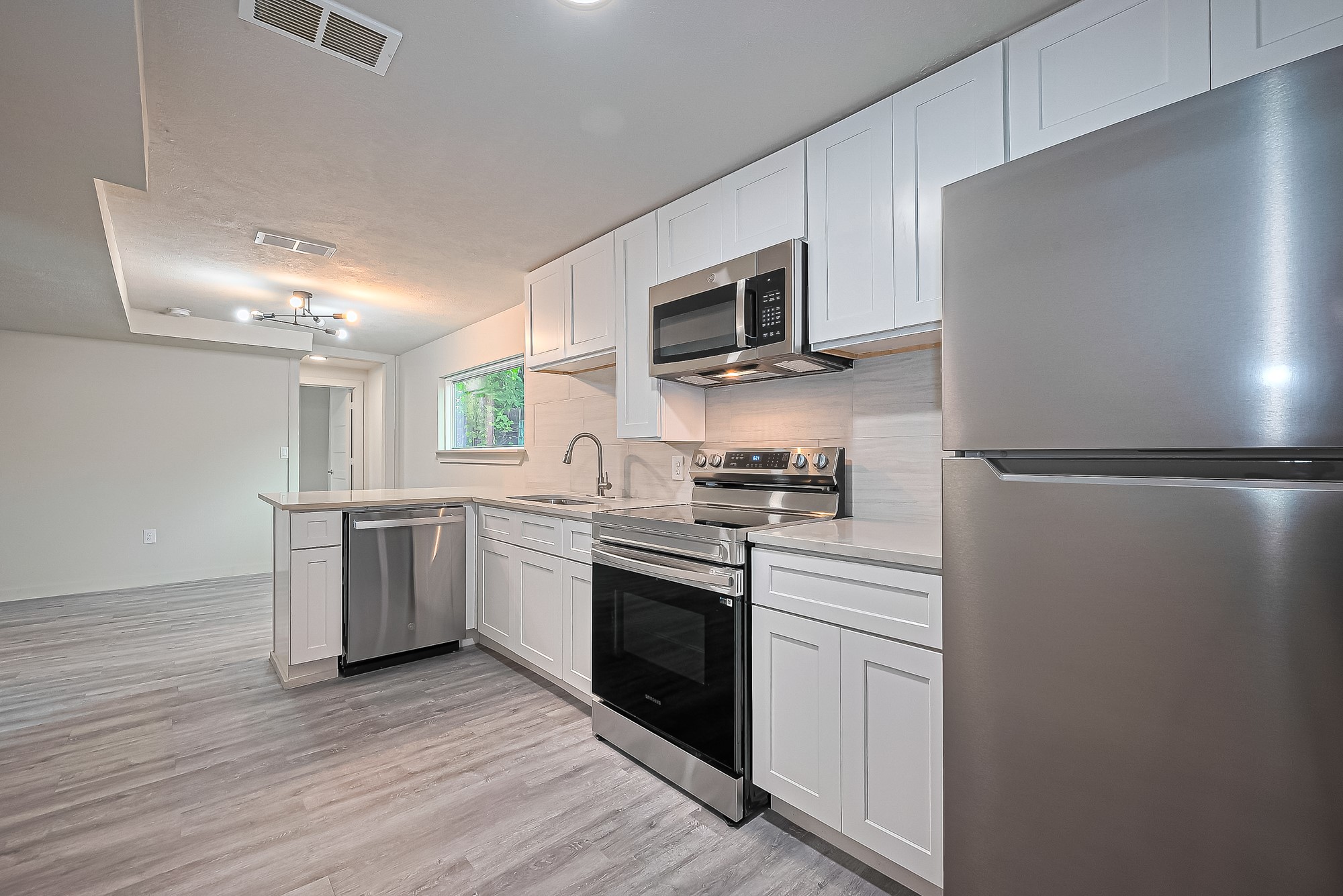 a kitchen with a refrigerator stove and microwave