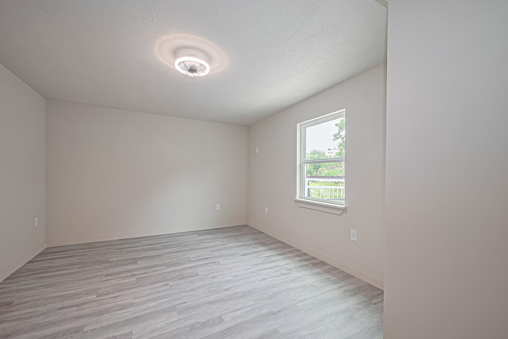 4013 Ranch Street, Unit 1 Houston, TX 77026 - Photo 12 of 16 an empty room with wooden floor and windows