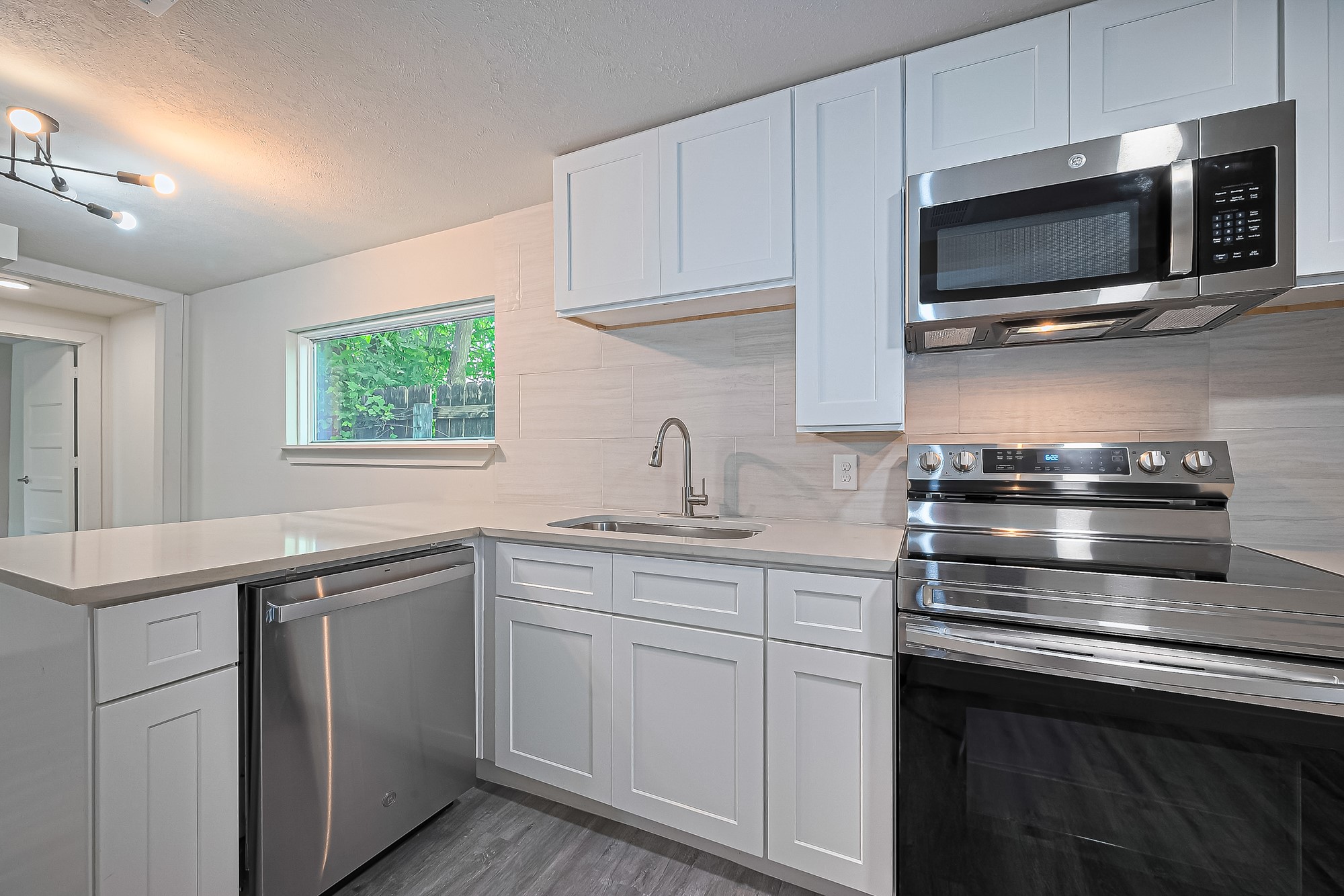 4013 Ranch Street, Unit 1 Houston, TX 77026 - Photo 4 of 16 a kitchen with a sink and steel appliances