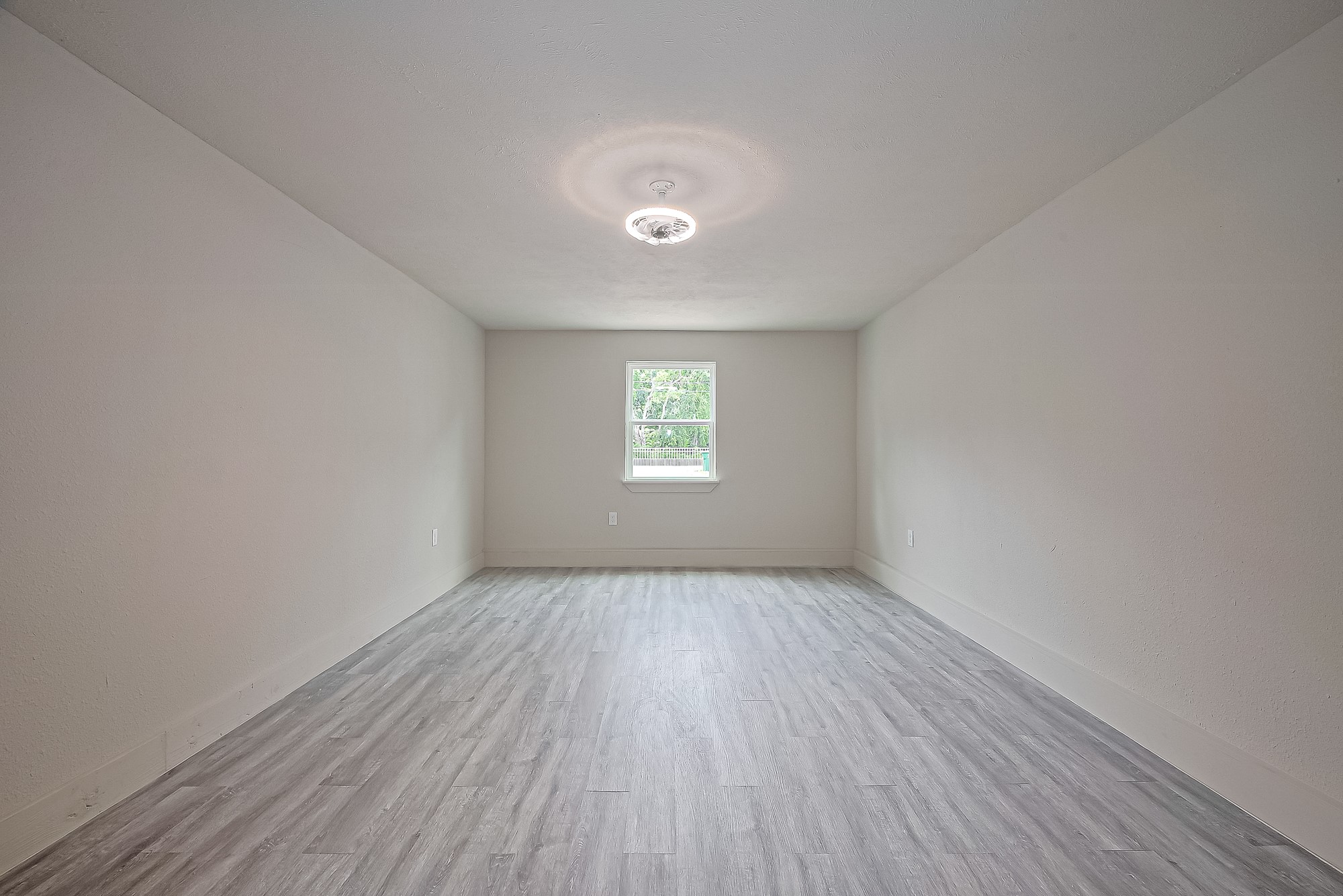 4013 Ranch Street, Unit 1 Houston, TX 77026 - Photo 9 of 16 an empty room with wooden floor and windows