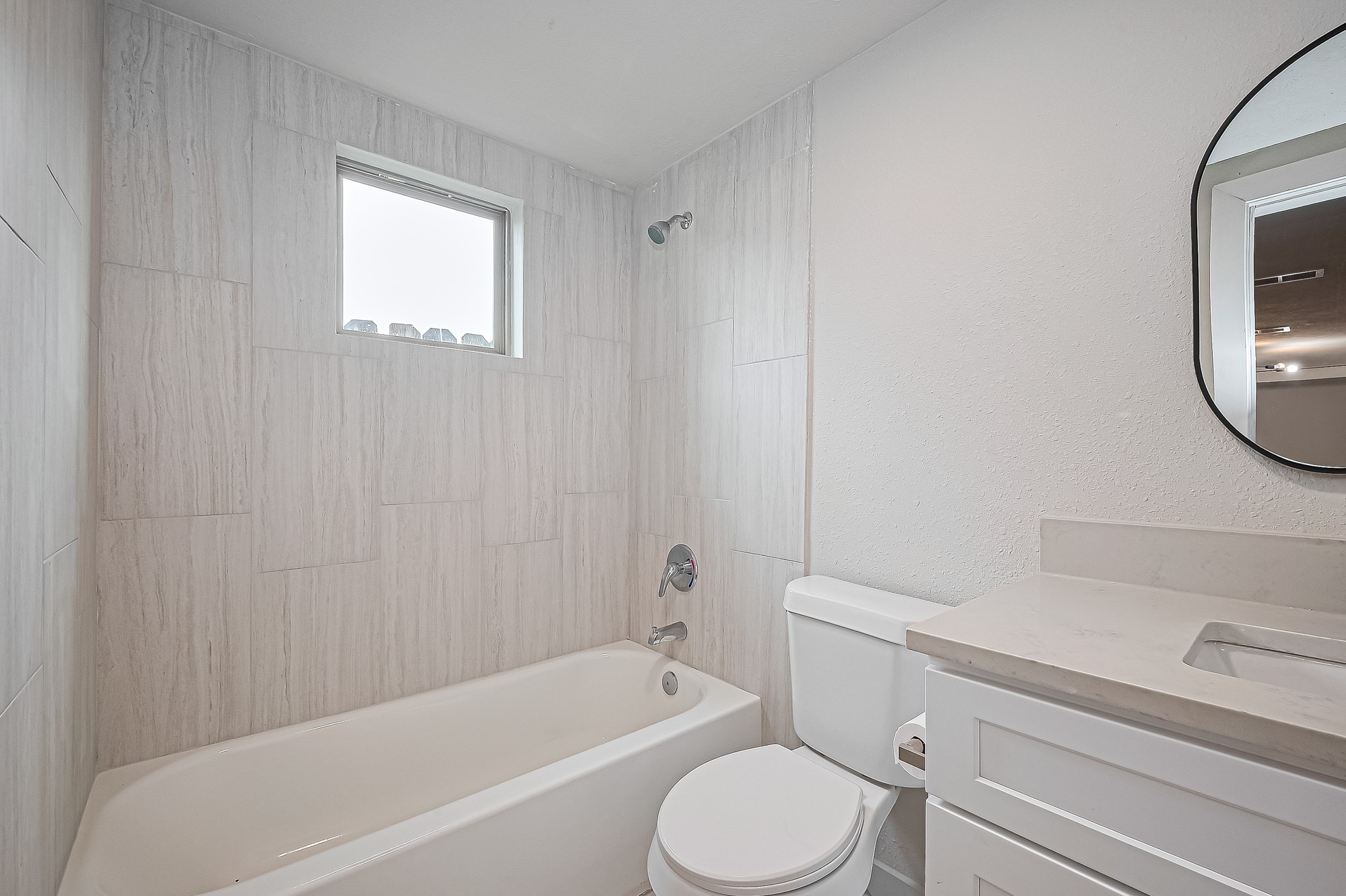 4013 Ranch Street, Unit 1 Houston, TX 77026 - Photo 10 of 16 a bathroom with a toilet a sink a mirror and bathtub