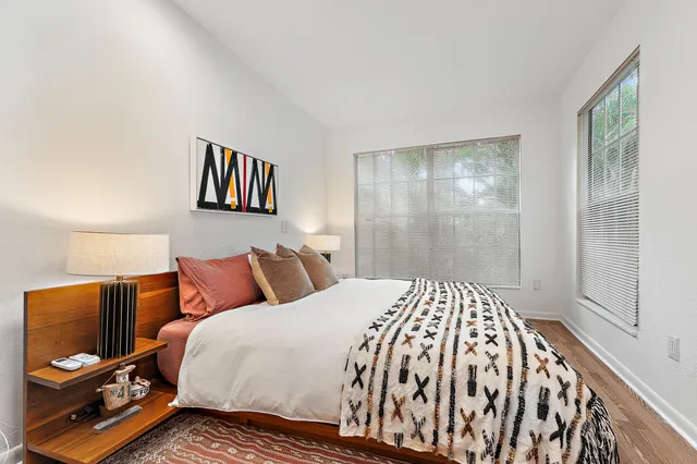 a bedroom with a bed and wooden floor