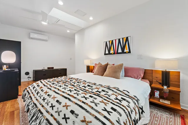 a bedroom with a bed and dresser