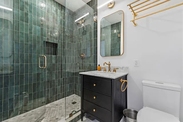 a bathroom with a sink toilet and shower