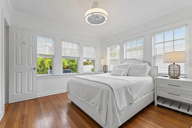 a bedroom with a bed and a large window