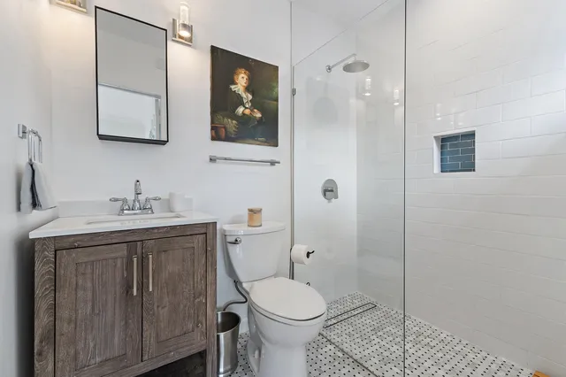 a bathroom with a toilet sink and mirror