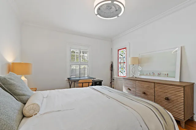 a bedroom with a bed and a chandelier