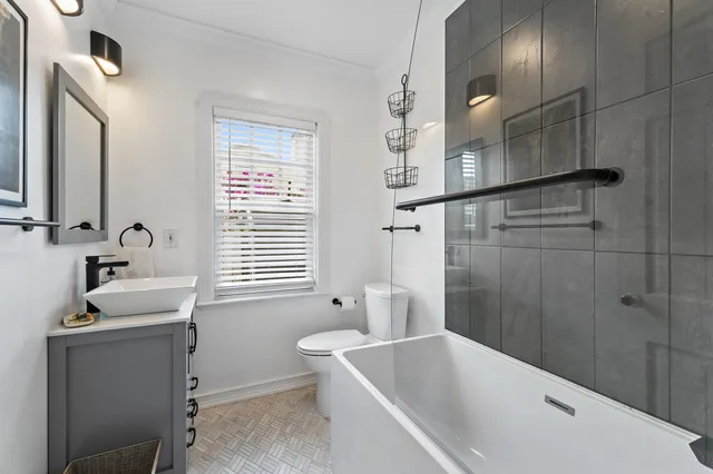 a bathroom with a tub sink and mirror