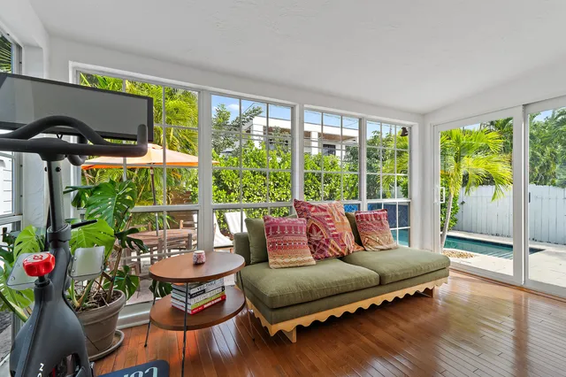 a living room with furniture and a potted plant