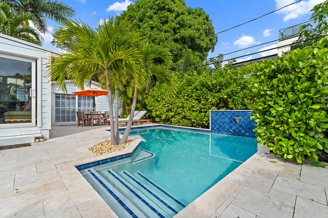 a view of a backyard with sitting area