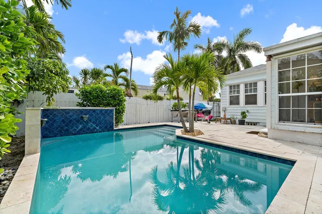 a swimming pool with outdoor seating yard and plants