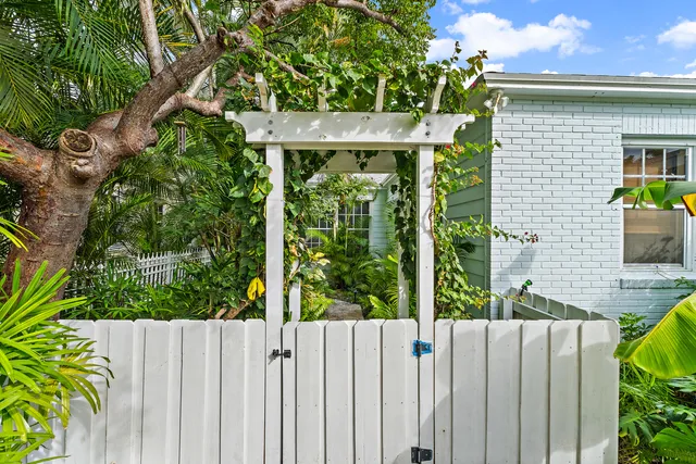 a view of a garden with wooden fence