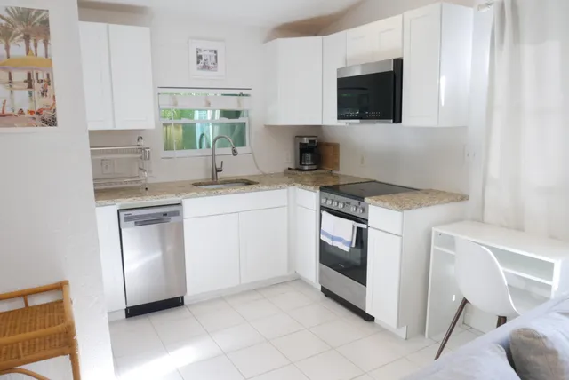 a kitchen with a sink cabinets and window