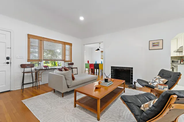 a living room with furniture a rug and a large window