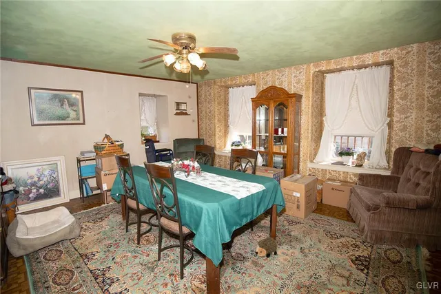 a view of a dining room with furniture and a chandelier