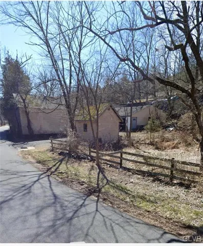 a view of a house with a large tree