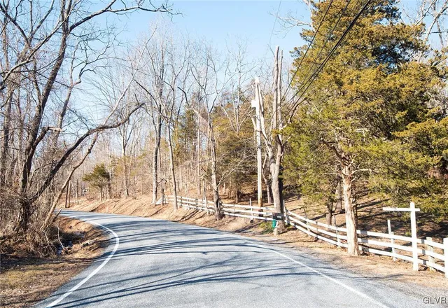 a view of wooden fence and trees