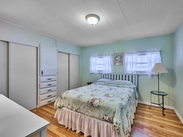 a bedroom with a bed and a lamp with window