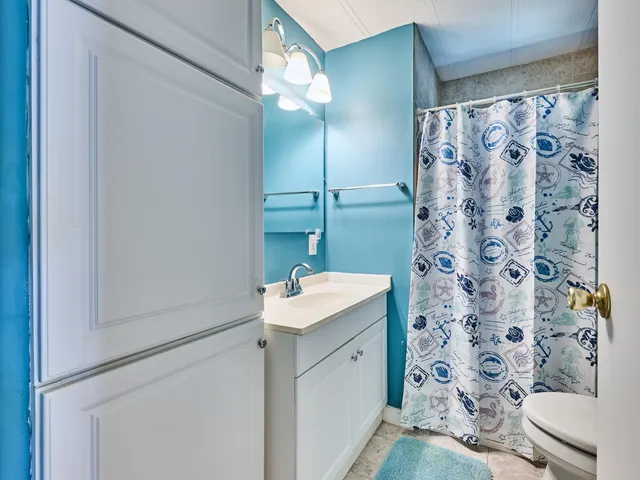 a bathroom with a toilet and a shower