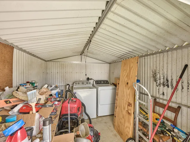 a living room with furniture pool table and a flat screen tv