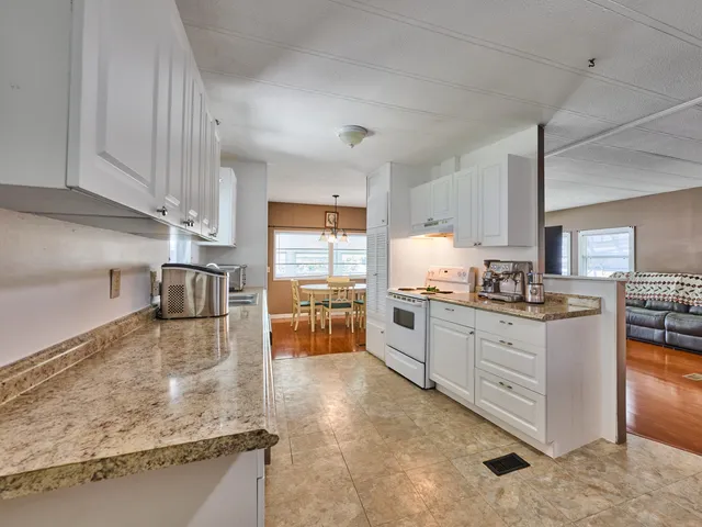 a kitchen with stainless steel appliances granite countertop a refrigerator sink and cabinets