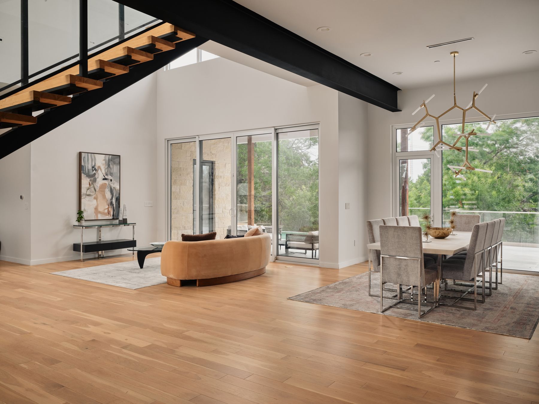 2476 Waymaker Way Austin, TX 78746 - Photo 31 of 31 An open floorplan with high ceilings and extensive natural light creates an inviting living and dining space.