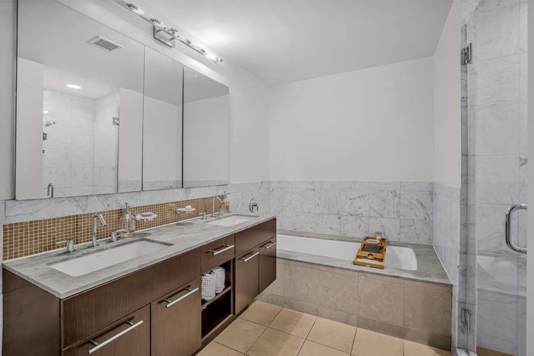 261 West 28th Street, Unit 9C Manhattan, NY 10001 - Photo 7 of 12 a bathroom with a sink and a mirror