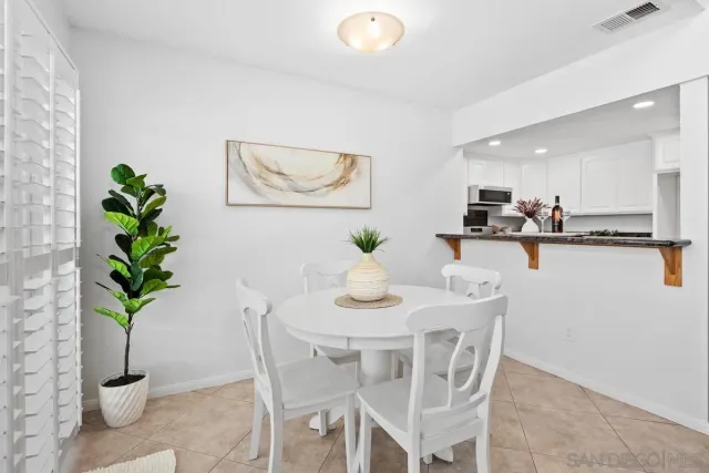 a dining room with furniture and potted plant