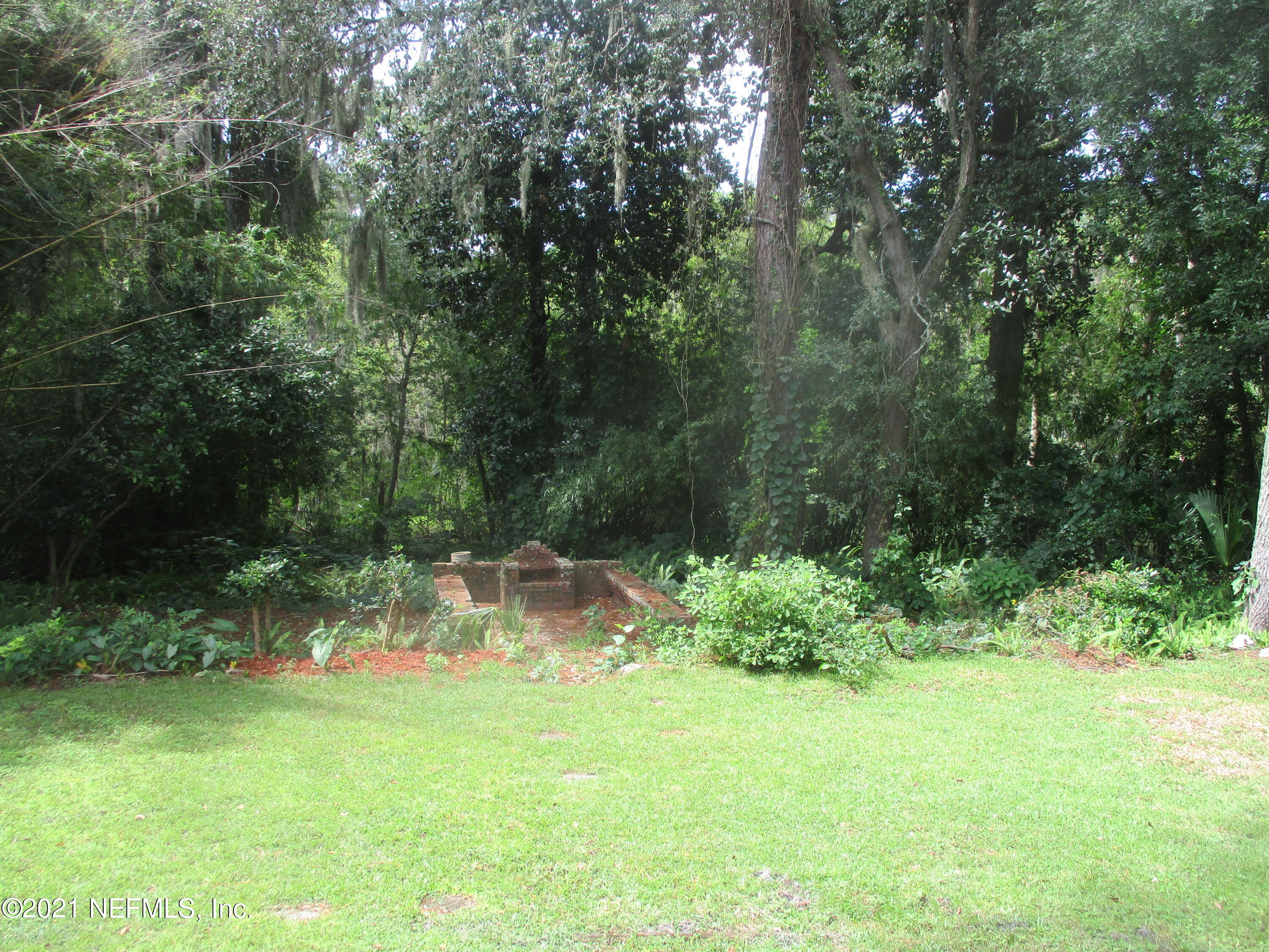 1620 Mayfair Road Jacksonville, FL 32207 - Photo 17 of 17 a backyard of a house with lots of green space and garden