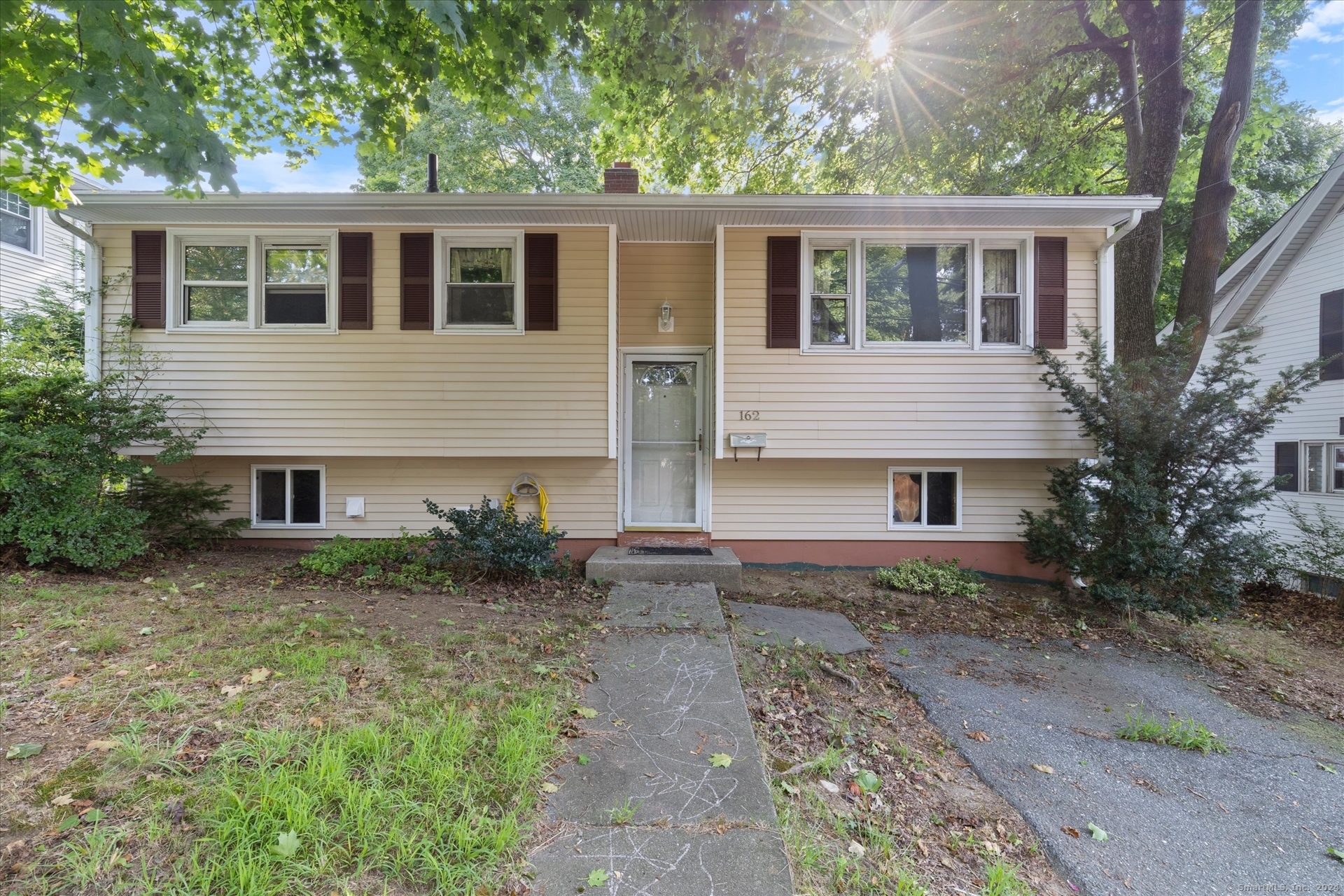 162 Mitchell Street Groton, CT 06340 - Photo 1 of 1 a backyard of a house with large trees and a yard