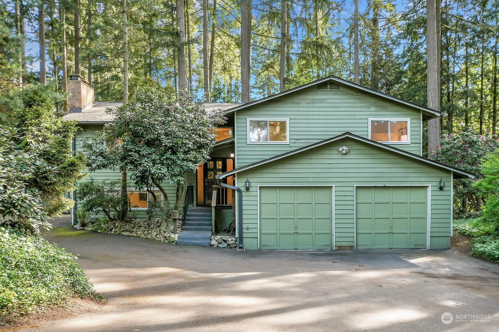 318 170th Place Southwest Bothell, WA 98012 - Photo 2 of 34 a front view of a house with a yard and garage