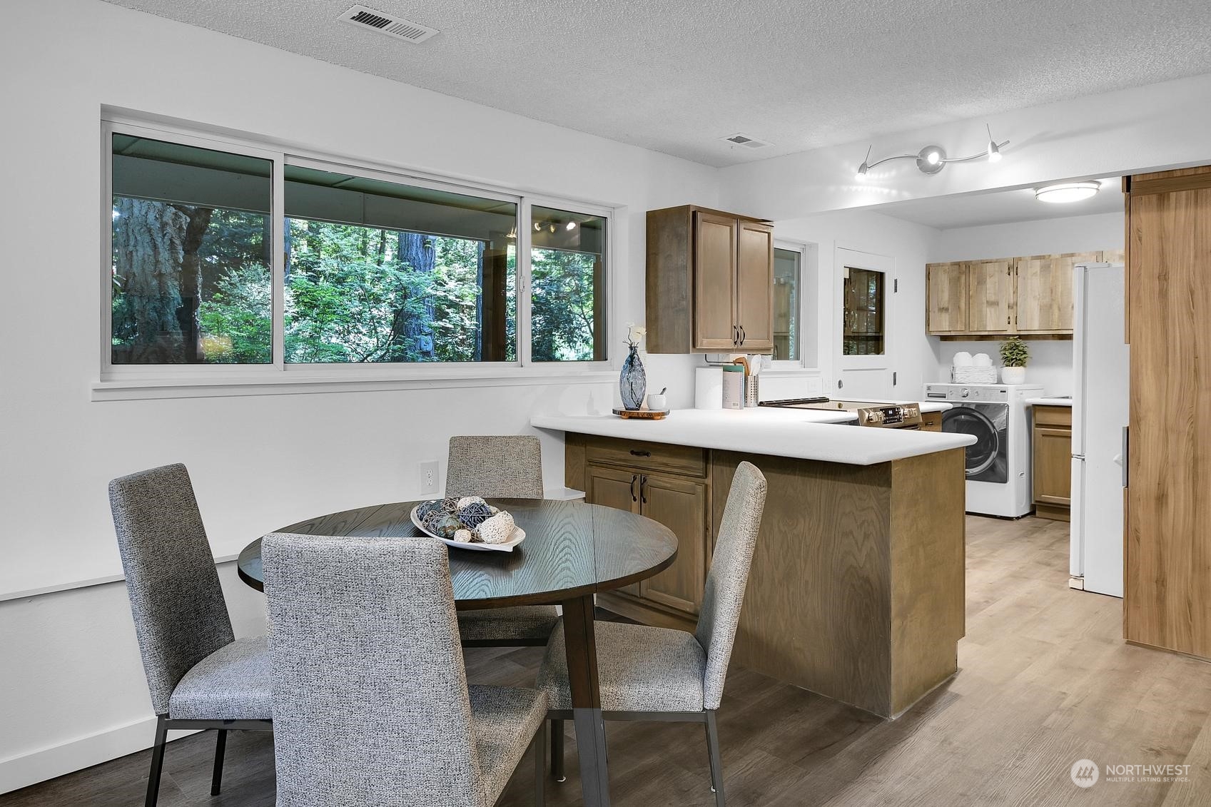 318 170th Place Southwest Bothell, WA 98012 - Photo 24 of 34 a dining table with chairs and window