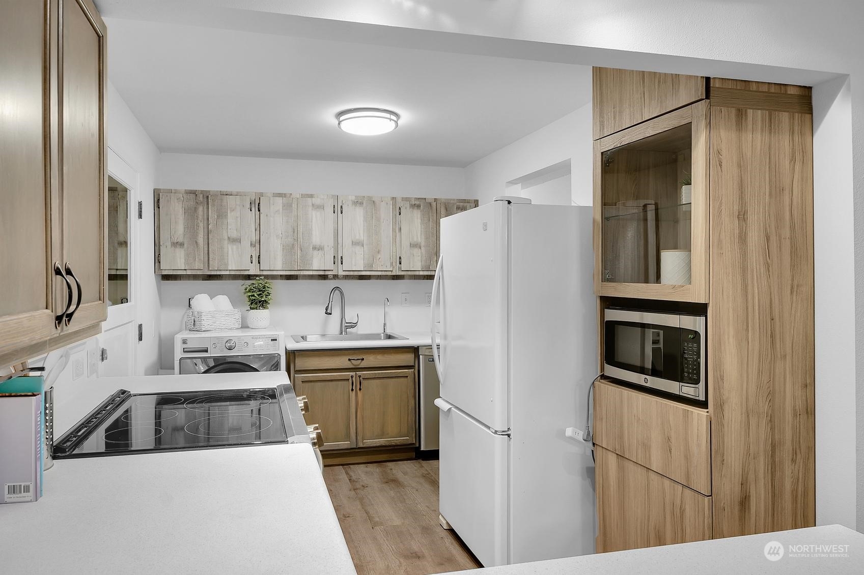 318 170th Place Southwest Bothell, WA 98012 - Photo 25 of 34 a kitchen with a sink a refrigerator and cabinets