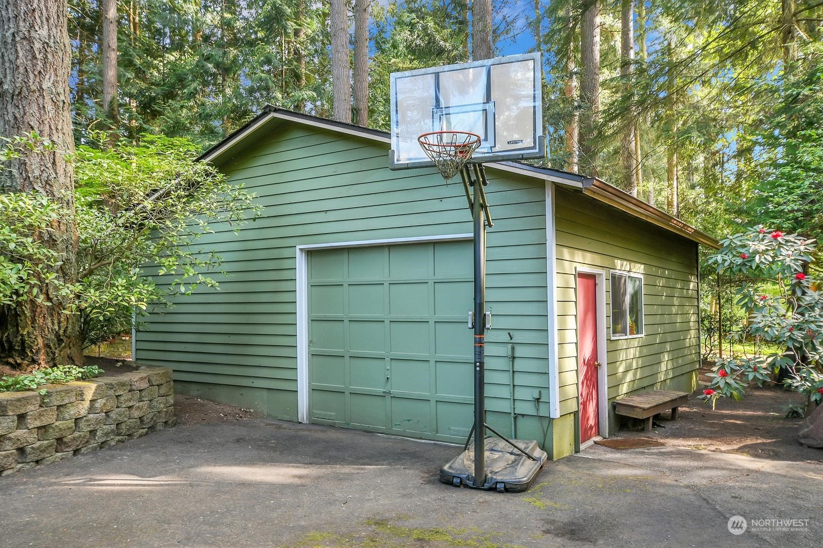 318 170th Place Southwest Bothell, WA 98012 - Photo 28 of 34 a small barn with a table and chairs and a large tree