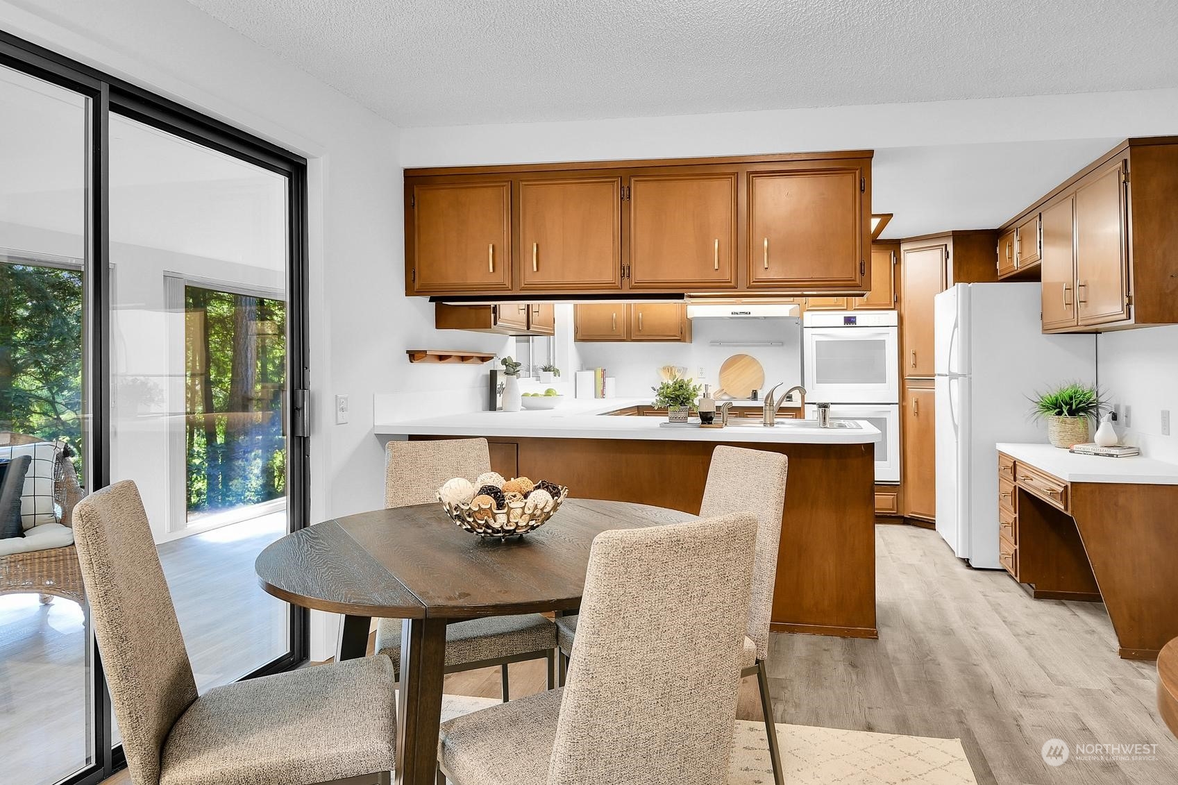 318 170th Place Southwest Bothell, WA 98012 - Photo 9 of 34 a kitchen with stainless steel appliances kitchen island granite countertop a table chairs in it and wooden floor