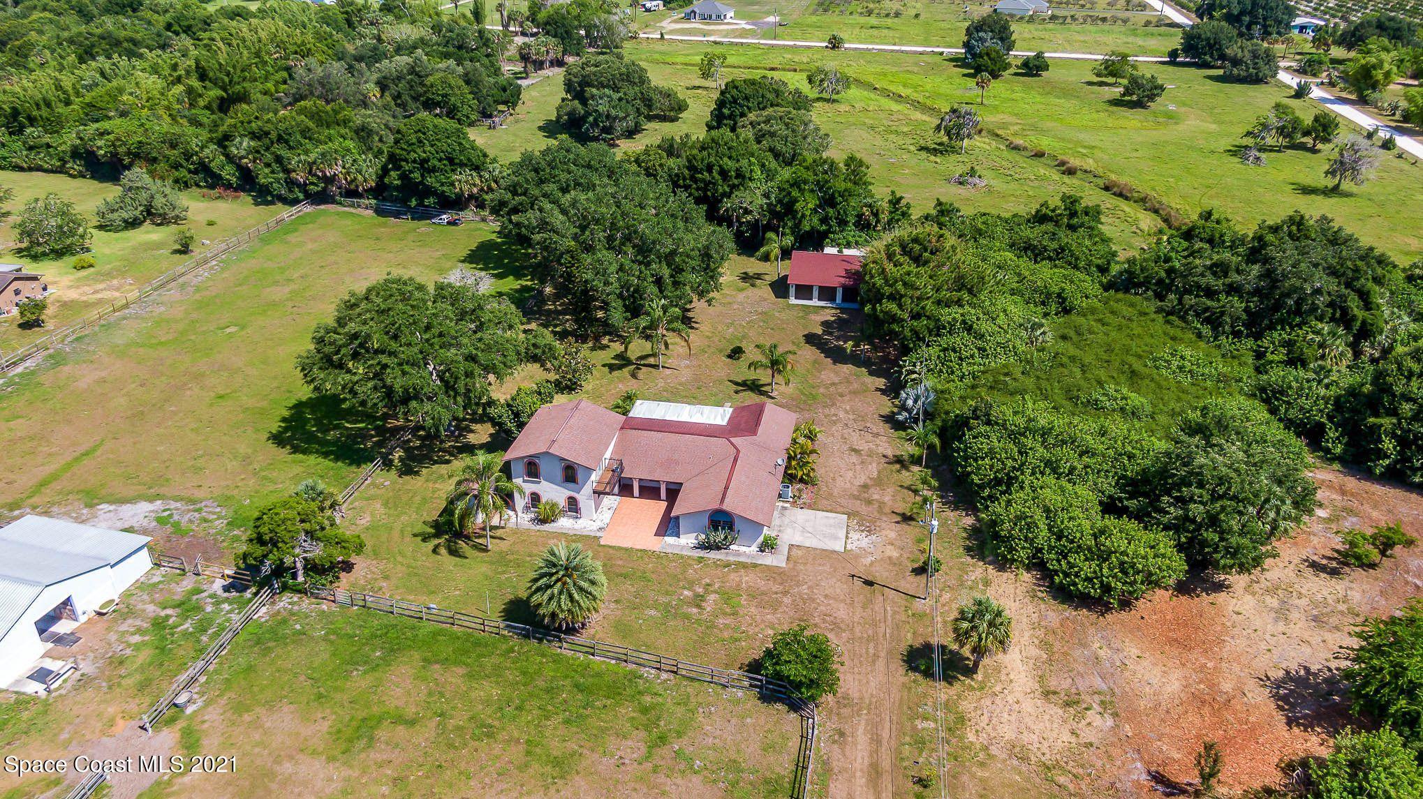 3330 Grant Line Road Mims, FL 32754 - Photo 40 of 42 an aerial view of a house with a yard and lake view