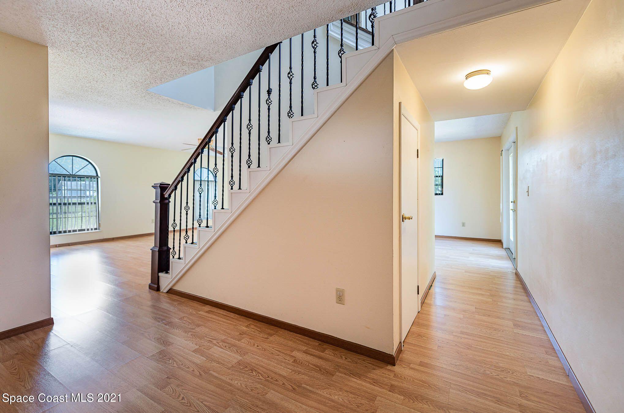 3330 Grant Line Road Mims, FL 32754 - Photo 8 of 42 a view of a hallway with wooden floor and entryway
