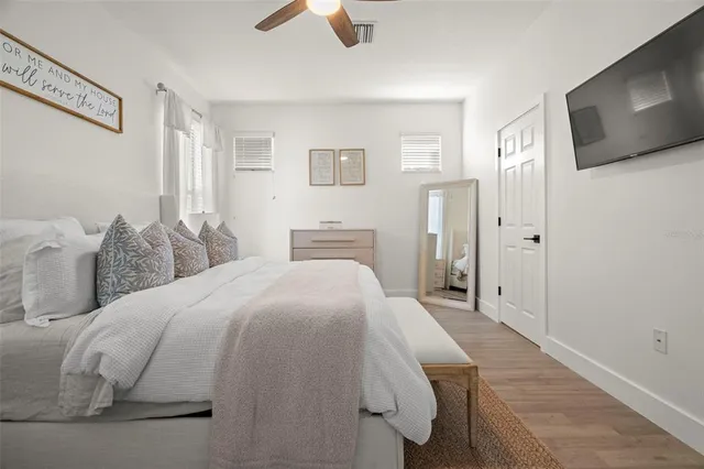 a bed room with a bed and a television