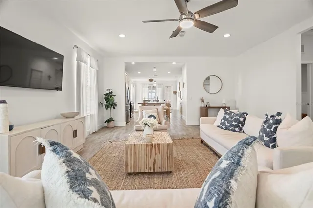 a spacious bedroom with a bed and a flat screen tv