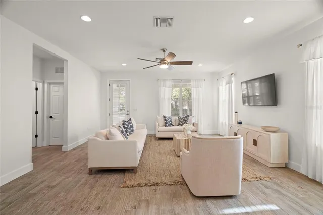 a bedroom with a bed and a flat tv screen on dresser