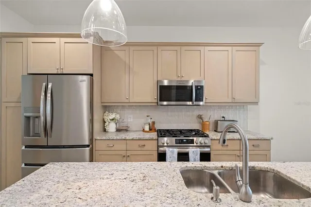 a bathroom with a double vanity sink mirror and shower