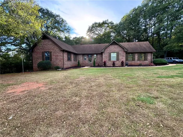 a house with huge green field in front of it