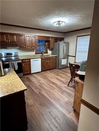 a room with wooden floor and furniture