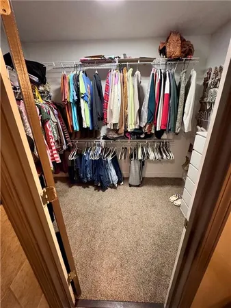 a spacious bedroom with a large bed and a dresser