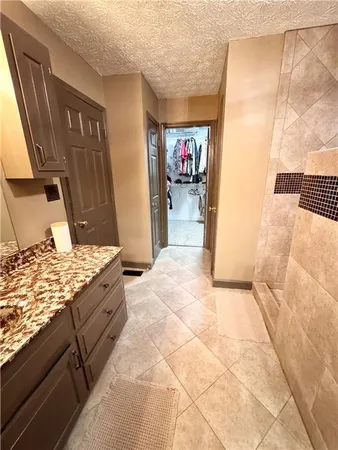 a bedroom with a bed and dresser with mirror