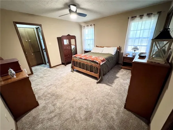 a bathroom with a granite countertop toilet sink and mirror
