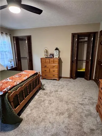 a bathroom with a granite countertop sink a mirror a bathtub and shower