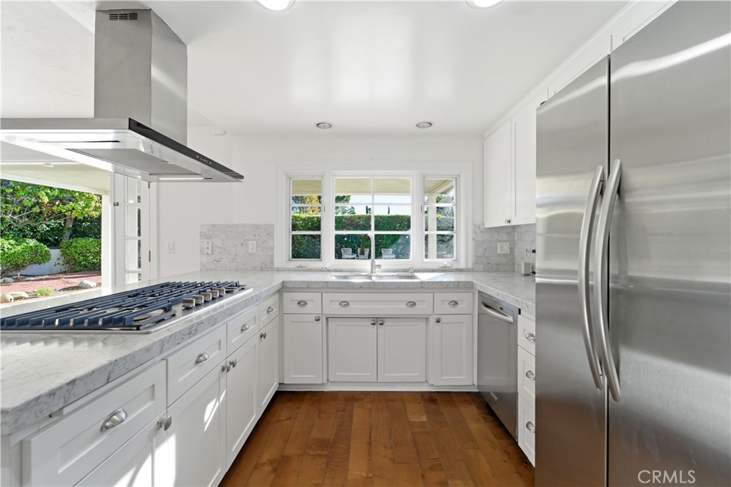 11344 Baird Avenue Porter Ranch, CA 91326 - Photo 12 of 45 a kitchen with granite countertop a sink stainless steel appliances and cabinets